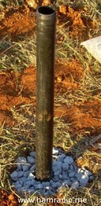 Fill hole with gravel around pipe