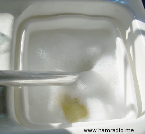 Removing oils and greases from aluminum with detergent.