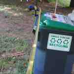 Measuring pipe between the trash bins