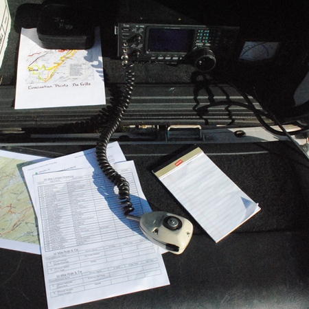 Net control tailgate desk with Motorola mic, info papers and pad. Radio is Icom IC-746.