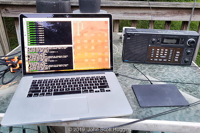 Laptop with terminals to R-Pi transmitter and R-Pi sensor. Data file in red window. Shortwave receiver on right to verify when transmitter is on.